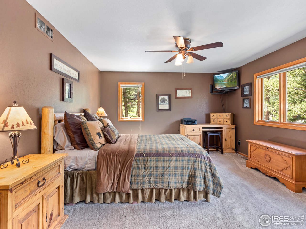 287 Wichita Road Lyons, CO 80540 - Photo 19 of 40 a bedroom with a bed and a chandelier