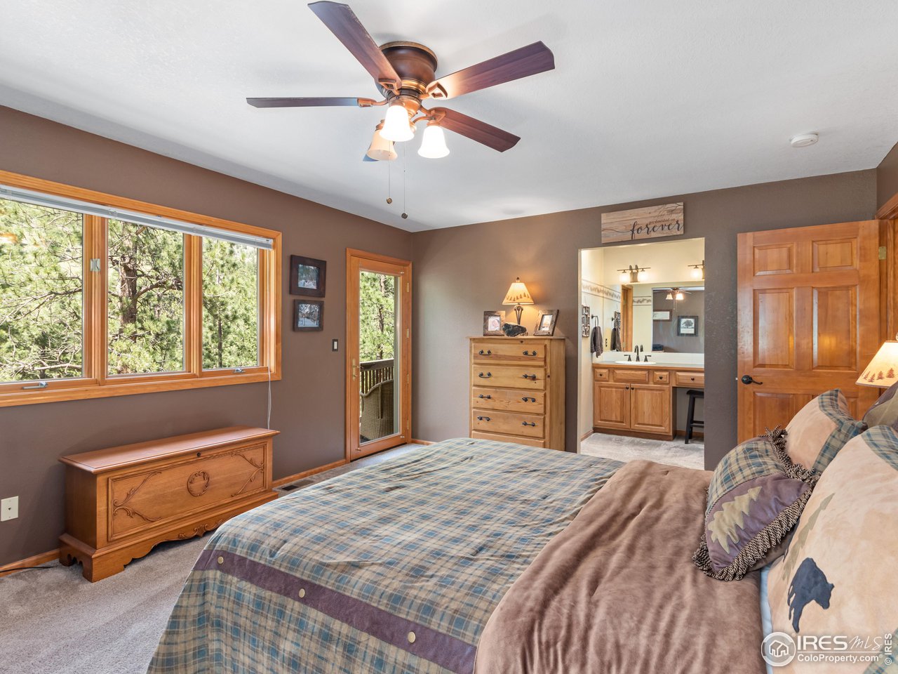 287 Wichita Road Lyons, CO 80540 - Photo 20 of 40 a bedroom with a large bed and a large window