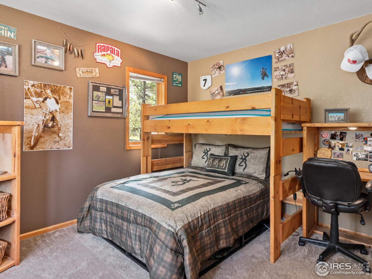 287 Wichita Road Lyons, CO 80540 - Photo 22 of 40 a bedroom with a bed a table and chair