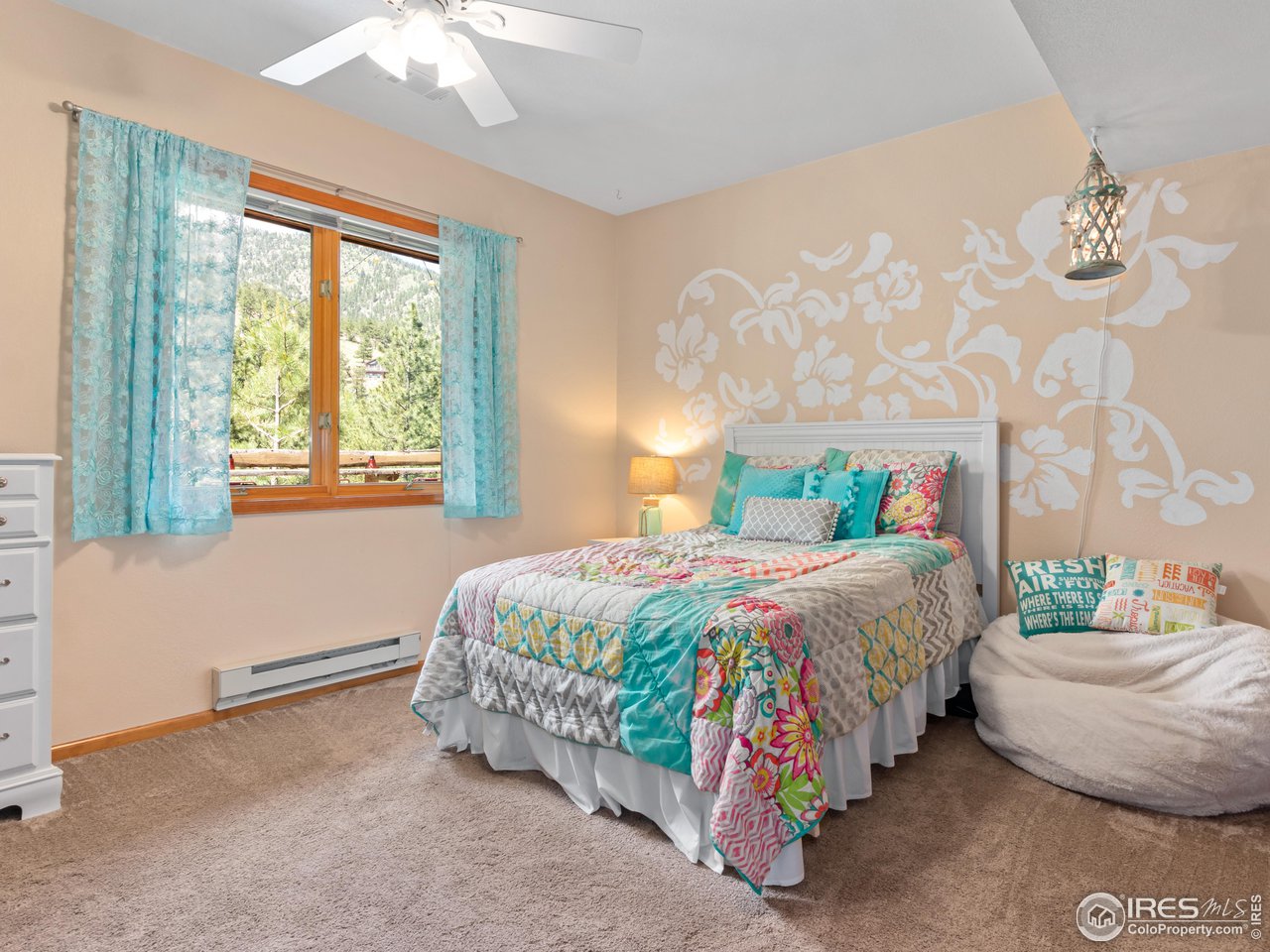 287 Wichita Road Lyons, CO 80540 - Photo 26 of 40 a bedroom with a bed and window
