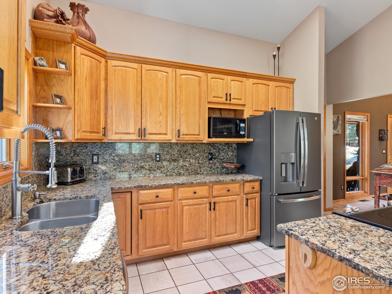 287 Wichita Road Lyons, CO 80540 - Photo 4 of 40 a kitchen with stainless steel appliances granite countertop a refrigerator stove and sink