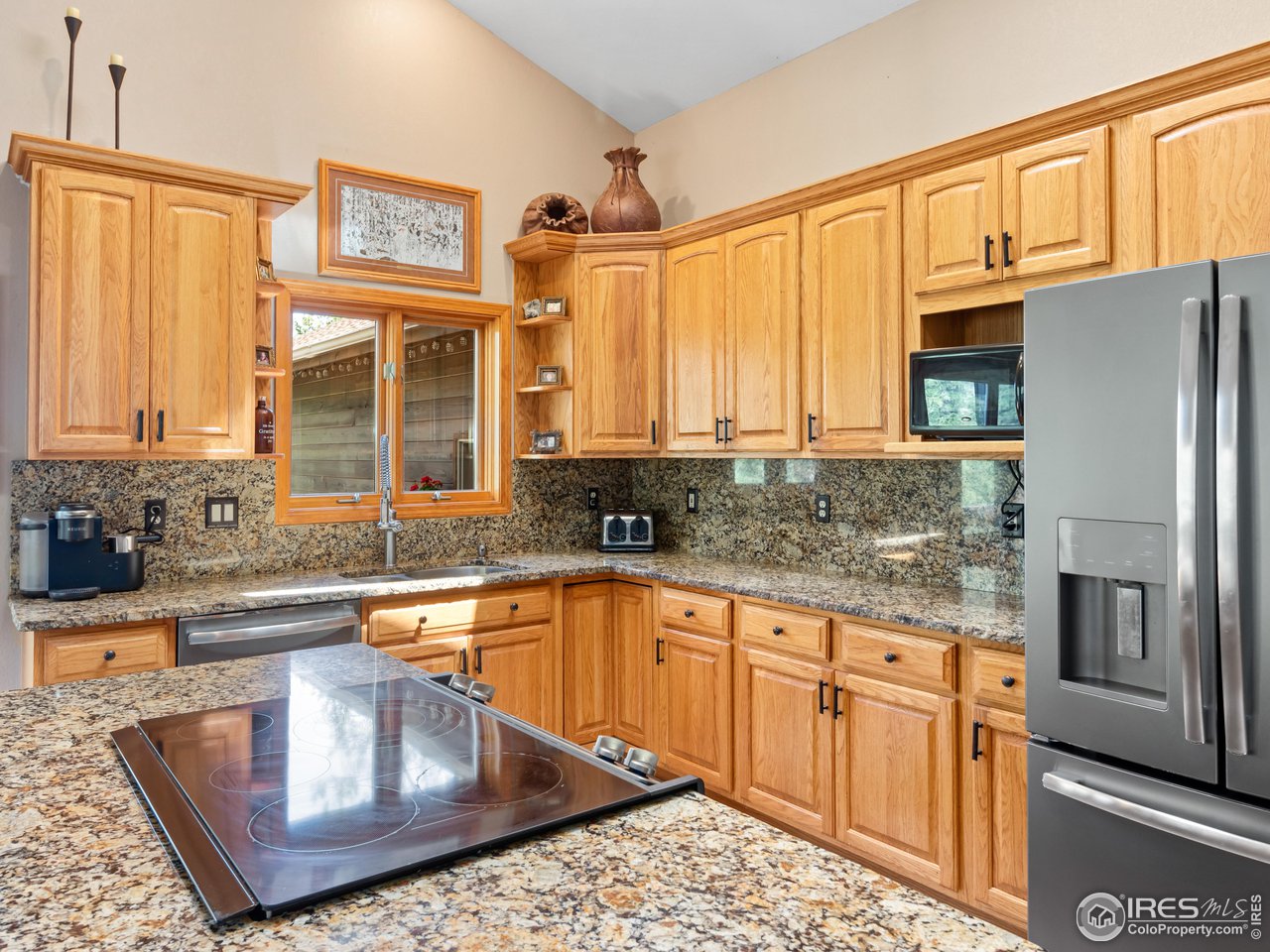 287 Wichita Road Lyons, CO 80540 - Photo 10 of 40 a kitchen with stainless steel appliances granite countertop a refrigerator a stove and a sink with granite countertops