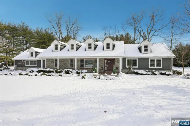 a front view of a house with yard and porch