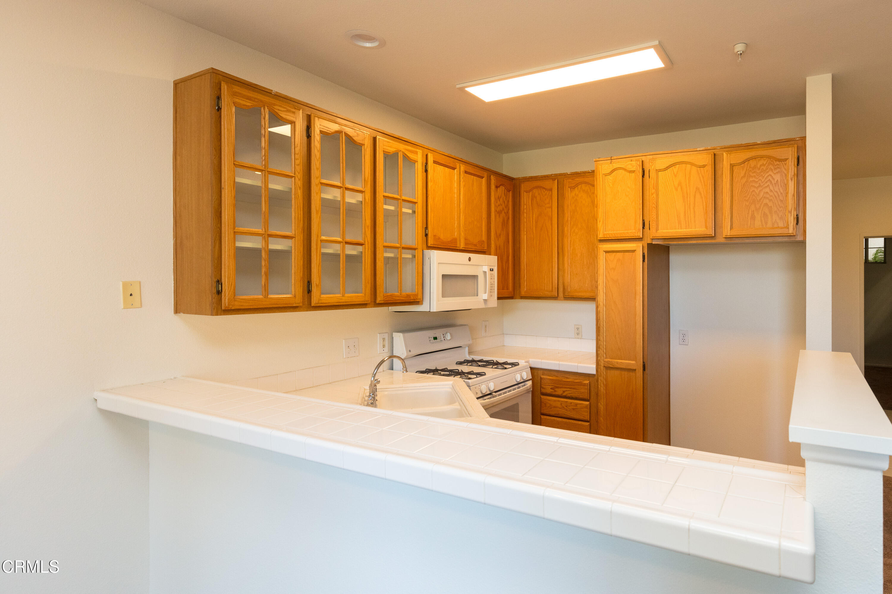 2913 Antonio Drive, Unit 106 Camarillo, CA 93010 - Photo 5 of 14 a bathroom with a sink and a large mirror