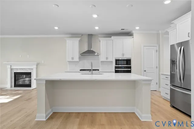 a kitchen with kitchen island a counter top space stainless steel appliances and cabinets