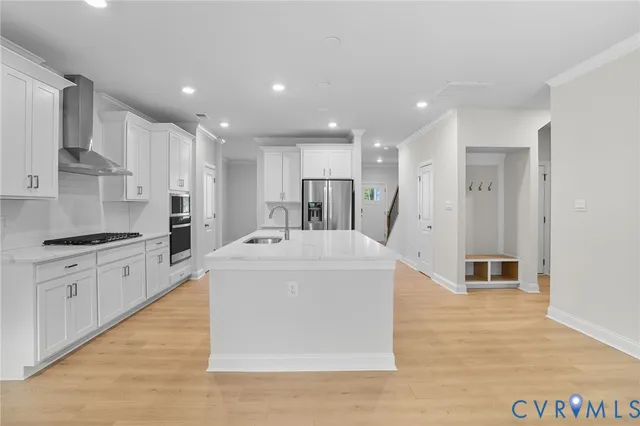 a large kitchen with stainless steel appliances kitchen island a large counter top and a stove top oven