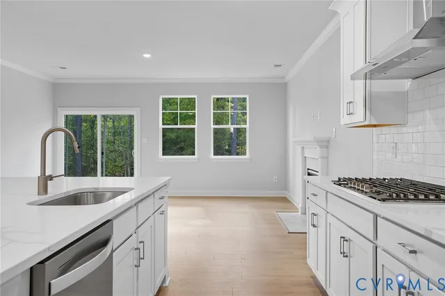 a kitchen with granite countertop a sink and a window