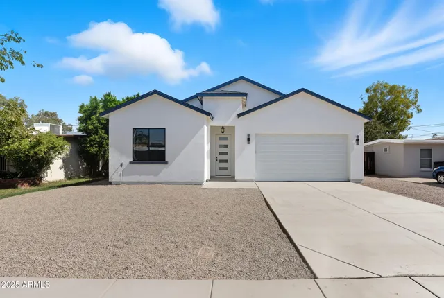 a view of a house with a yard and garage