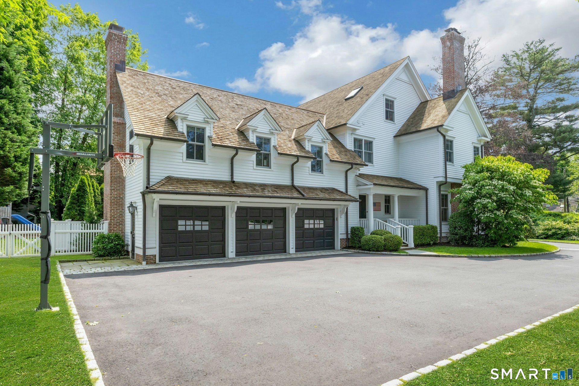 2 Roland Drive Darien, CT 06820 - Photo 39 of 40 a view of a white house with a big yard and large trees