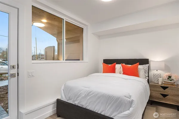 a bedroom with a bed and a mirror