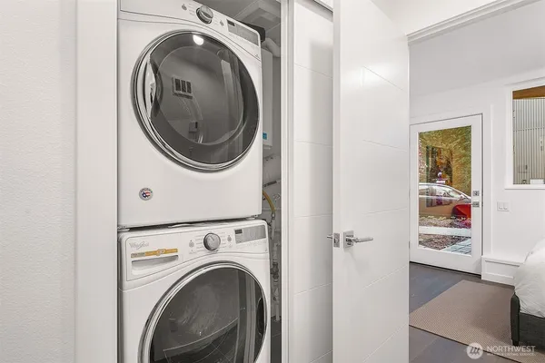 a view of a hallway with washer and dryer
