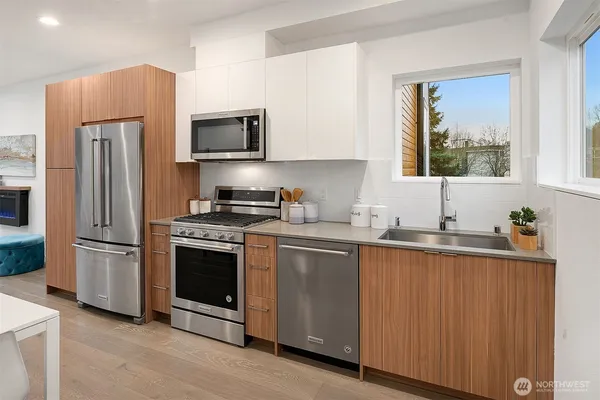 a kitchen with stainless steel appliances a refrigerator stove and sink