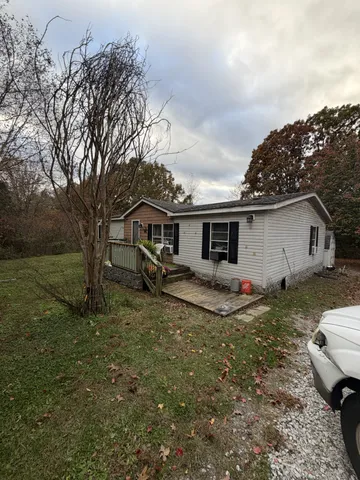 a view of a house with a chairs in a yard