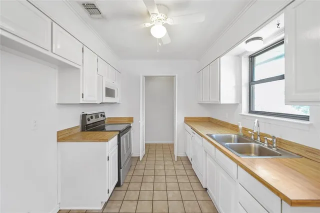 a kitchen with stainless steel appliances granite countertop a sink stove and cabinets