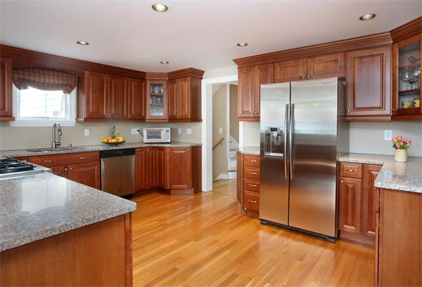 27 Haven Road Wellesley, MA 02481 - Photo 4 of 10 a kitchen with stainless steel appliances granite countertop a refrigerator a sink a stove a washer dryer and white cabinets