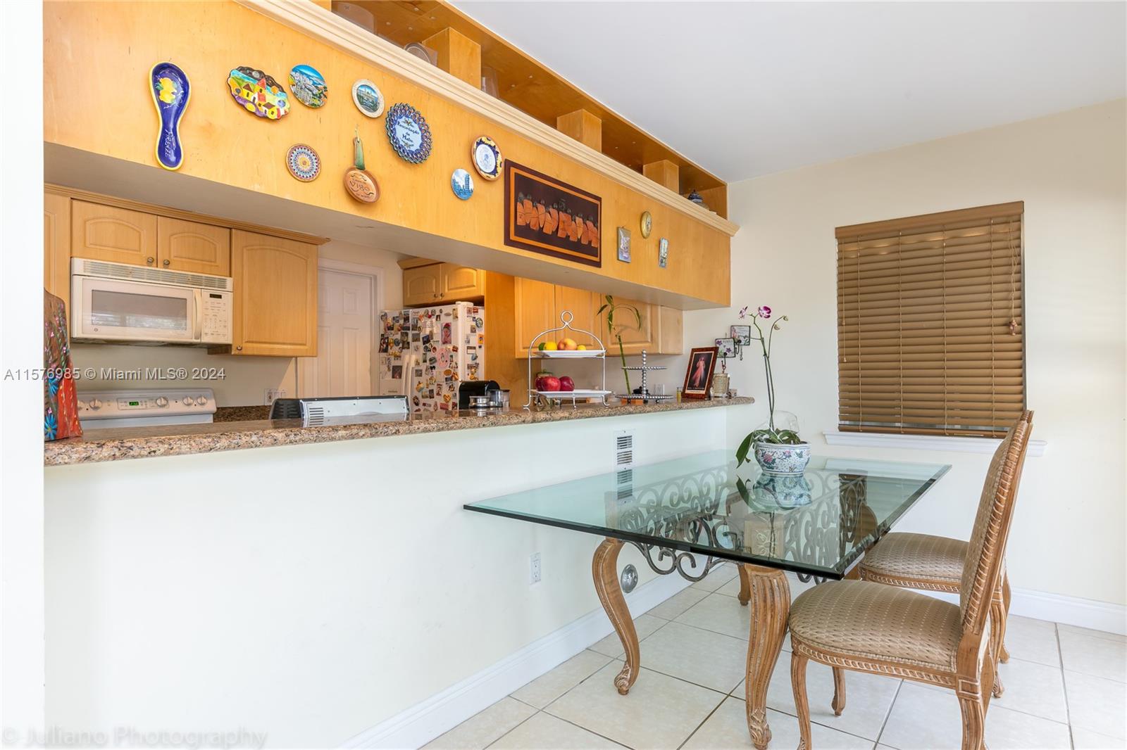 444 Fernwood Road, Unit 444 Key Biscayne, FL 33149 - Photo 15 of 28 a kitchen with a table and chairs in it