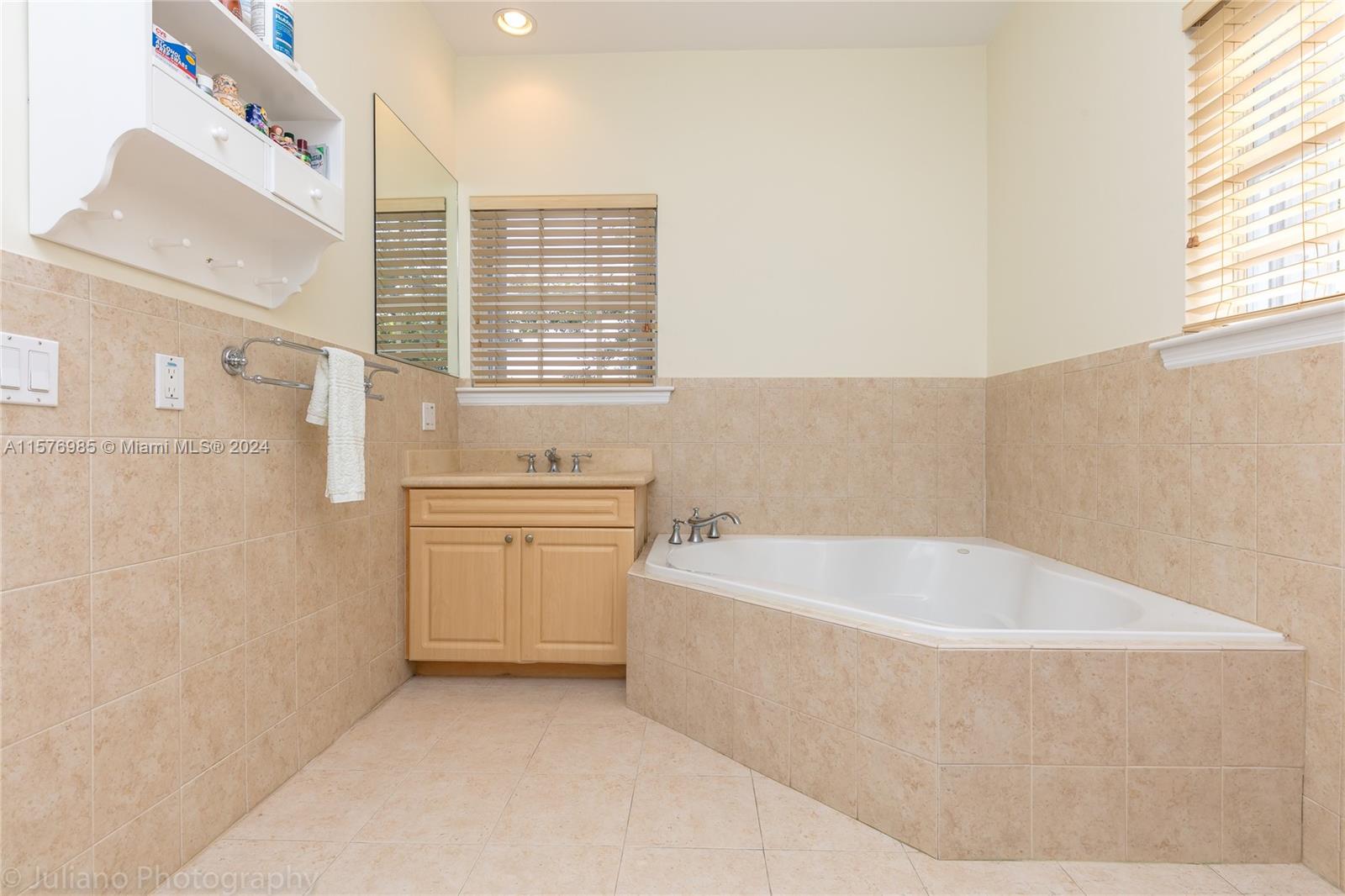 444 Fernwood Road, Unit 444 Key Biscayne, FL 33149 - Photo 20 of 28 a bathroom with a bathtub and sink