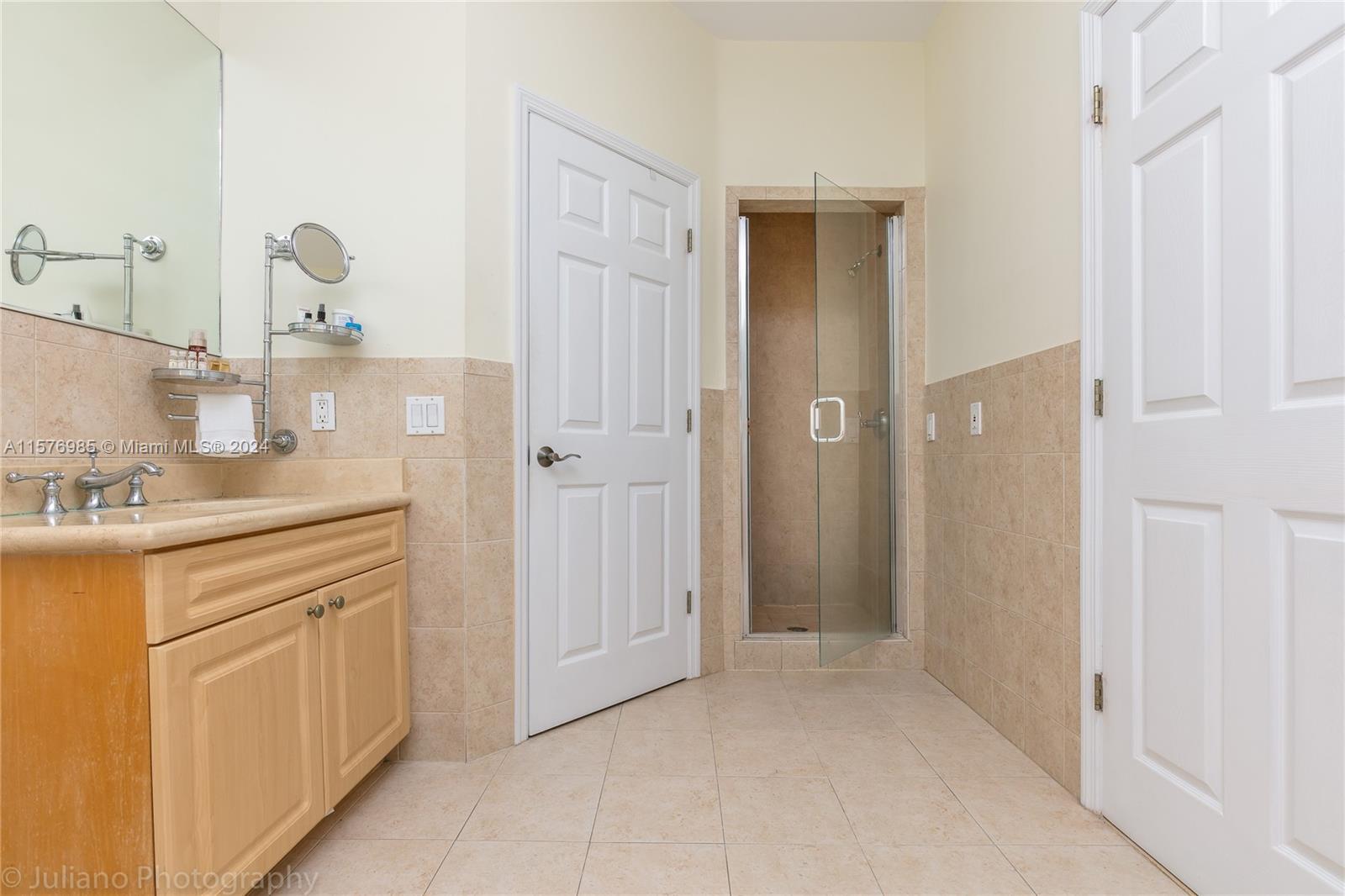 444 Fernwood Road, Unit 444 Key Biscayne, FL 33149 - Photo 22 of 28 a bathroom with a sink and a mirror