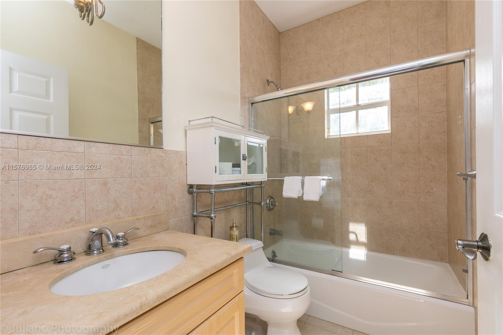444 Fernwood Road, Unit 444 Key Biscayne, FL 33149 - Photo 25 of 28 a bathroom with a granite countertop sink toilet and shower