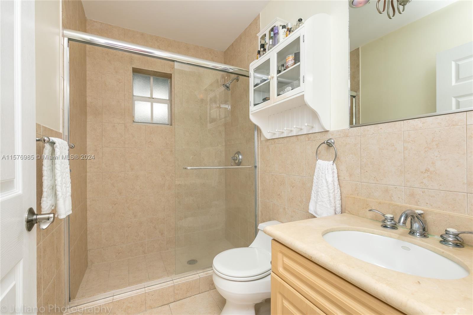 444 Fernwood Road, Unit 444 Key Biscayne, FL 33149 - Photo 26 of 28 a bathroom with a sink toilet and shower