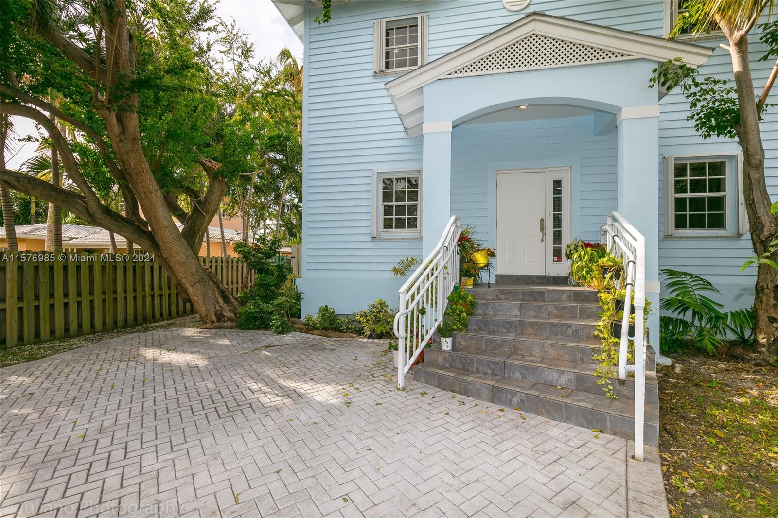 444 Fernwood Road, Unit 444 Key Biscayne, FL 33149 - Photo 3 of 28 a view of a house with wooden fence