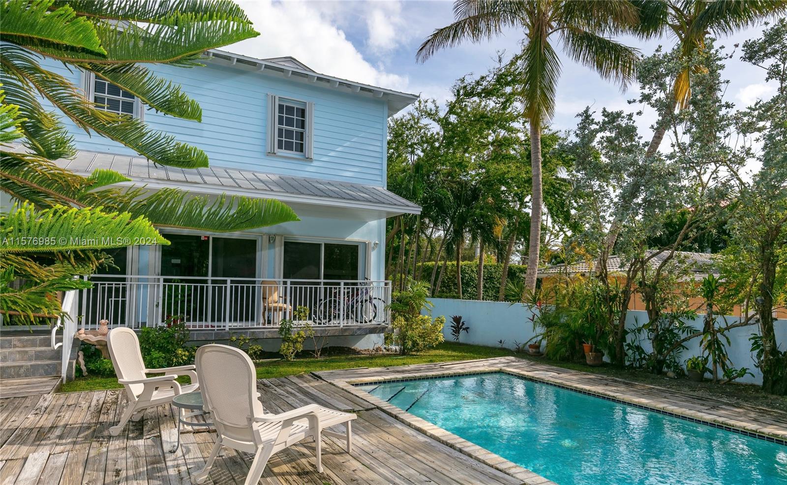 444 Fernwood Road, Unit 444 Key Biscayne, FL 33149 - Photo 5 of 28 a view of house with swimming pool and sitting area