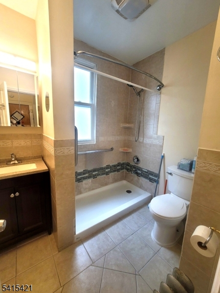 26 Harding Terrace Newark, NJ 07112 - Photo 2 of 6 a bathroom with a granite countertop toilet sink and mirror