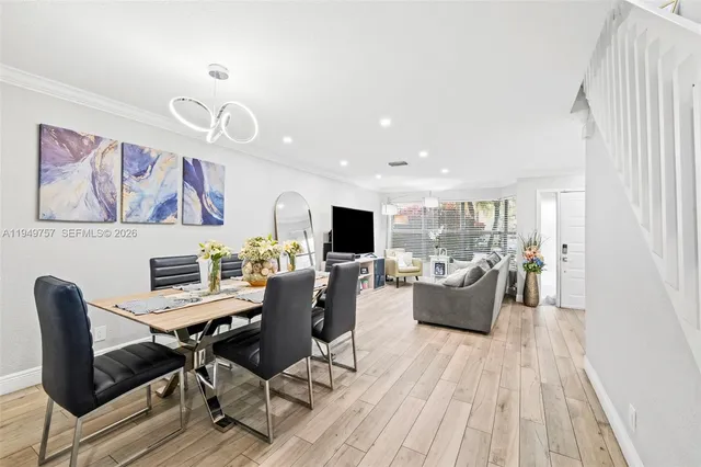 a view of a dining room with furniture window and wooden floor