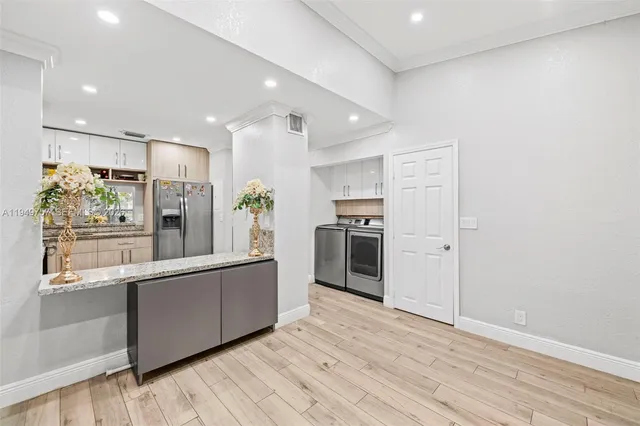 a kitchen with stainless steel appliances a refrigerator and a stove top oven