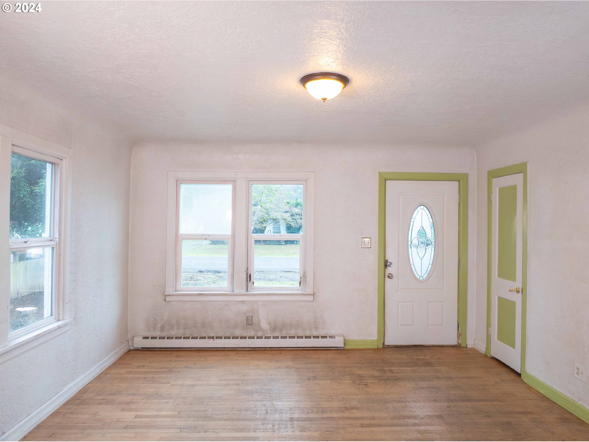 2947 Elmira Road Eugene, OR 97402 - Photo 3 of 29 an empty room with wooden floor and windows