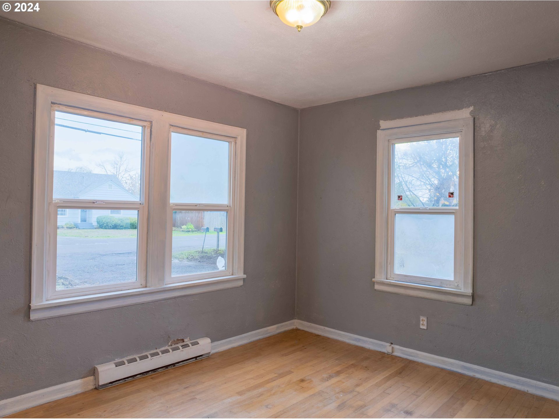 2947 Elmira Road Eugene, OR 97402 - Photo 6 of 29 a view of a room with wooden floor and windows