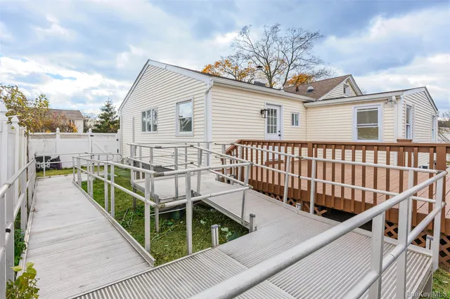 a view of a house with wooden fence