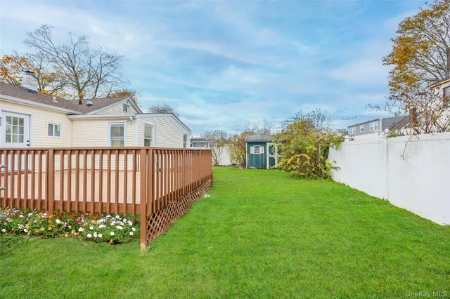 a view of a house with a yard and tree s