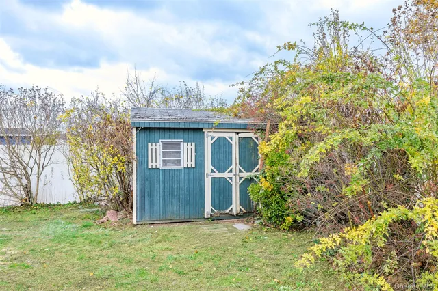 a view of a chairs with table in backyard