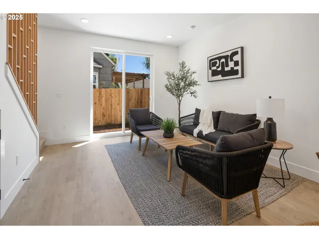 a living room with furniture and a kitchen view