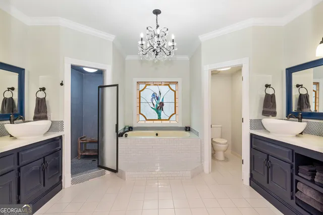 a view of a dining room with furniture a chandelier and wooden floor