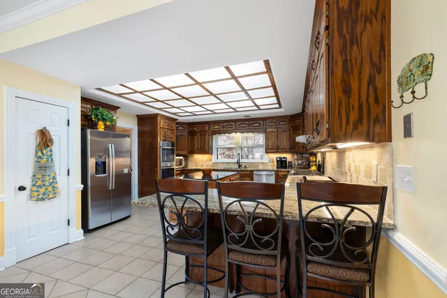 a living room with furniture and a gym machine