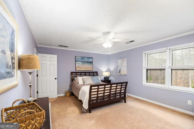 a view of a bedroom with closet and ceiling fan