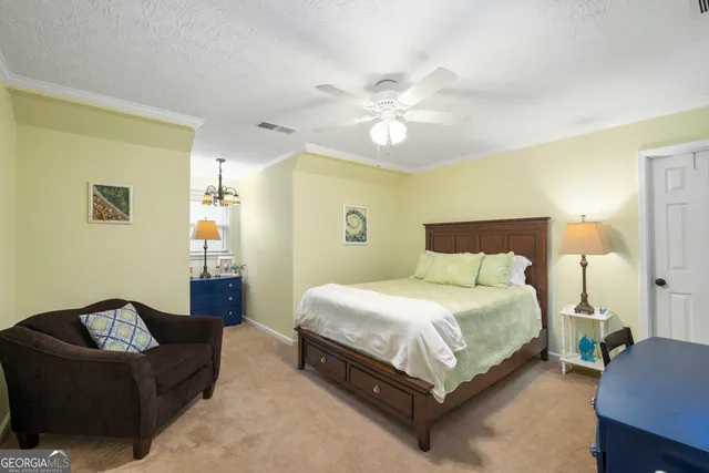 a view of a dining room with furniture a chandelier and window
