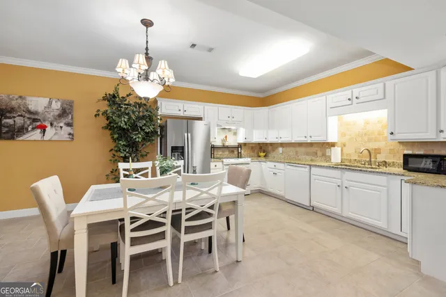 a view of swimming pool with outdoor seating and plants