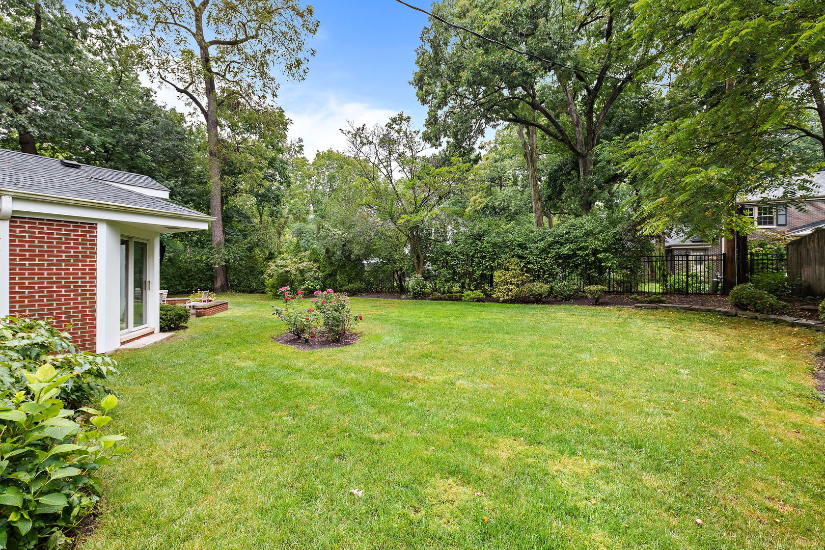 1369 Tower Road Winnetka, IL 60093 - Photo 24 of 31 a view of a chair and tables in the backyard of the house