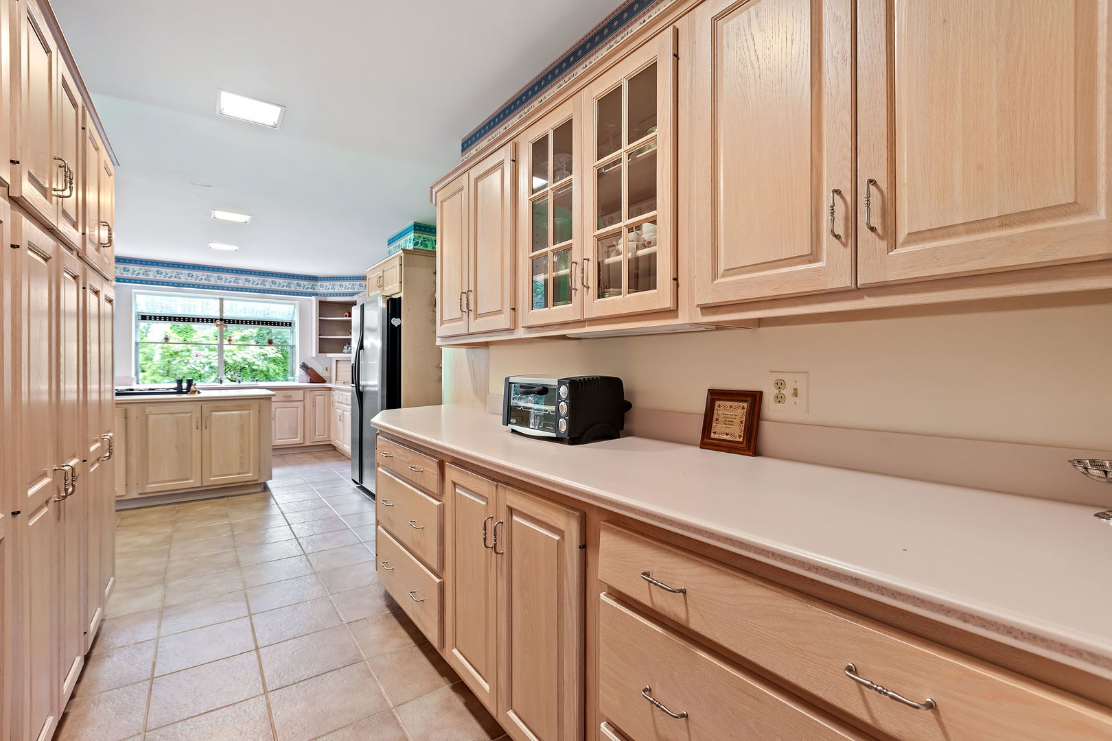 1369 Tower Road Winnetka, IL 60093 - Photo 7 of 31 a kitchen with stainless steel appliances granite countertop a sink and dishwasher with white cabinets