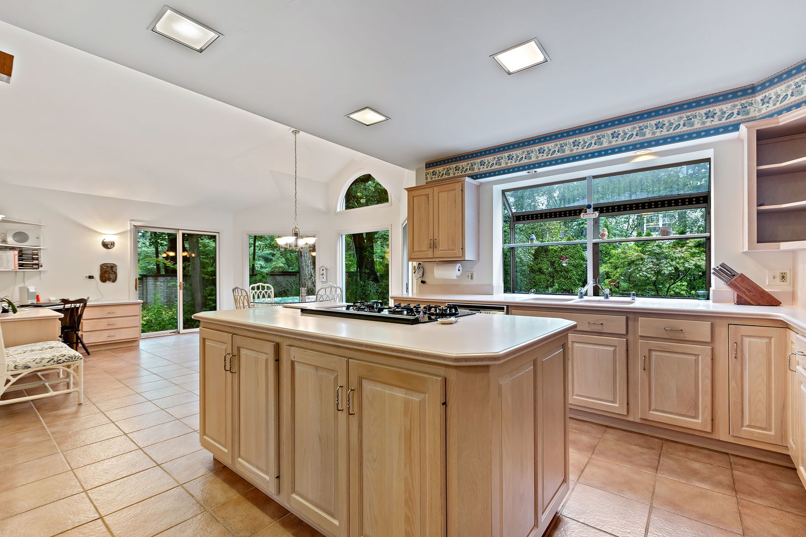 1369 Tower Road Winnetka, IL 60093 - Photo 8 of 31 a kitchen with kitchen island a large window in it