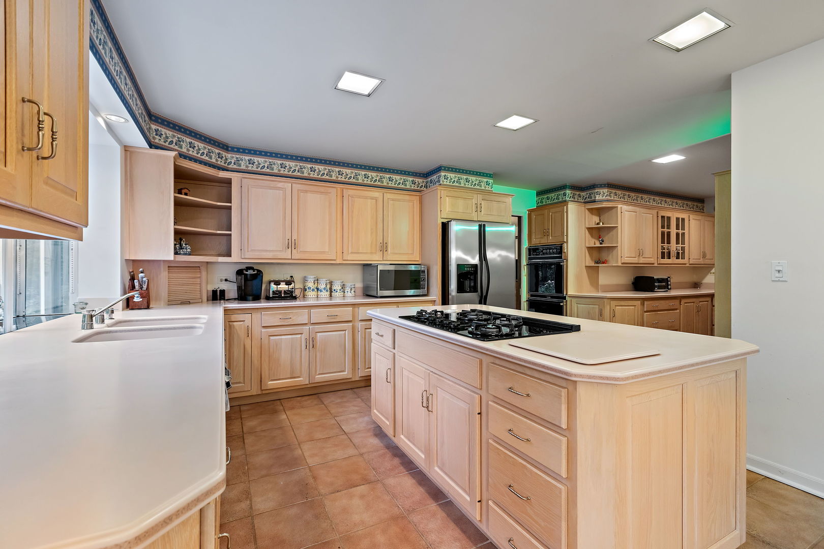 1369 Tower Road Winnetka, IL 60093 - Photo 10 of 31 a kitchen with stainless steel appliances a stove a sink and a refrigerator