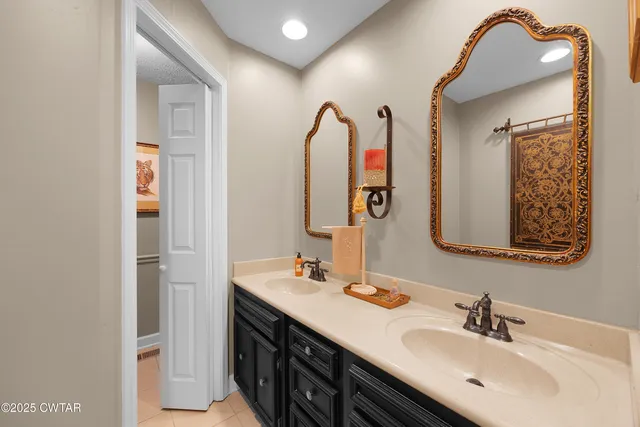 a bathroom with a double vanity sink and a mirror