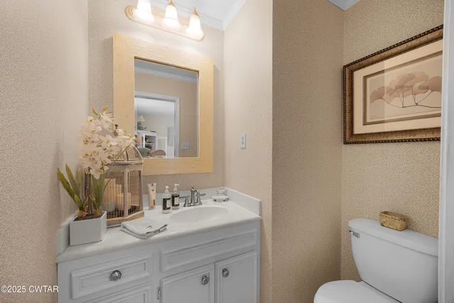 a bathroom with a toilet a sink and mirror