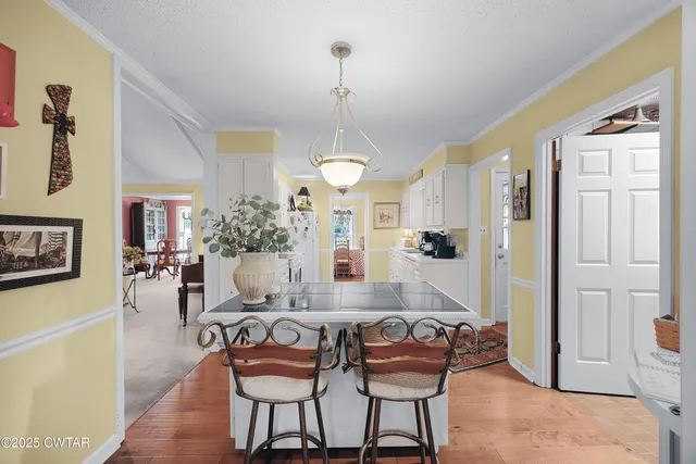 a living room with furniture a dining table and a chandelier