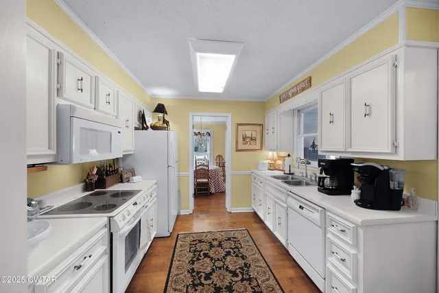 a kitchen with stainless steel appliances a refrigerator sink and cabinets