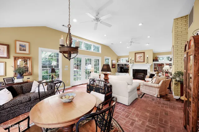 a living room with furniture large window and a fireplace