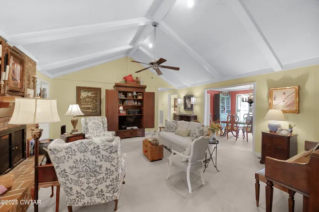 a living room with fireplace furniture and a wooden floor
